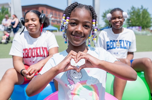 girl making heart with hands