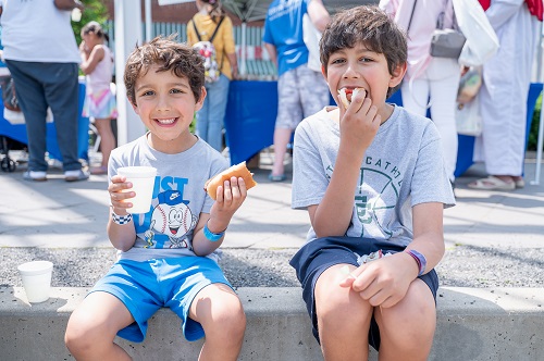 boys enjoying hotdogs